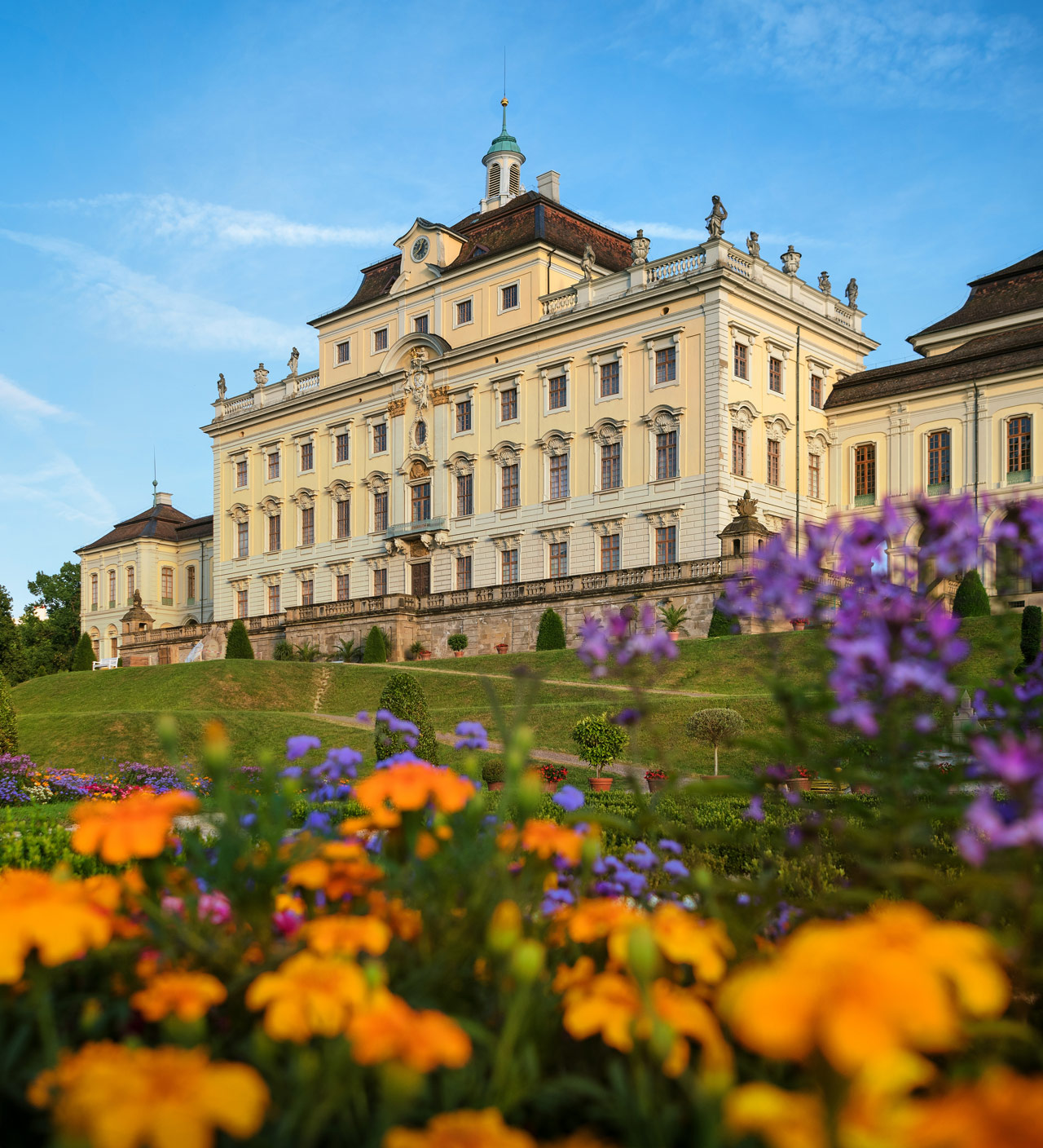 Außenansicht des Residenzschlosses Ludwigsburg. Bunte Blumen im Vordergrund.